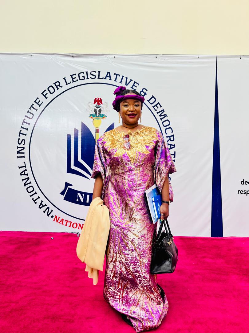 Anna Philemon Dara standing before the National Institute for Legislative and Democratic Studies backdrop.