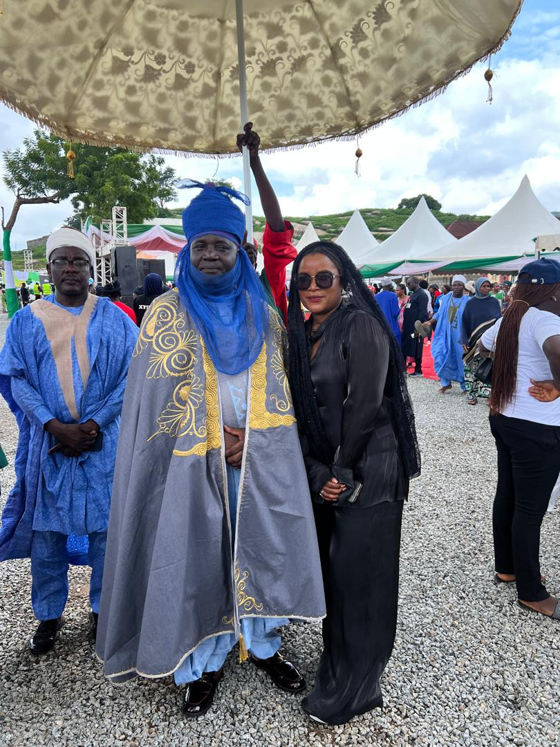 Anna Philemon Dara standing with His Royal Highness Sa Bwaya, Dr. Ibrahim Yaro JP, at an outdoor gathering.